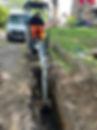 A tractor digging into the ground.
