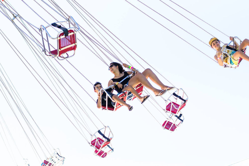 Image of a mother and child high in the sky on a ride at an amusement park