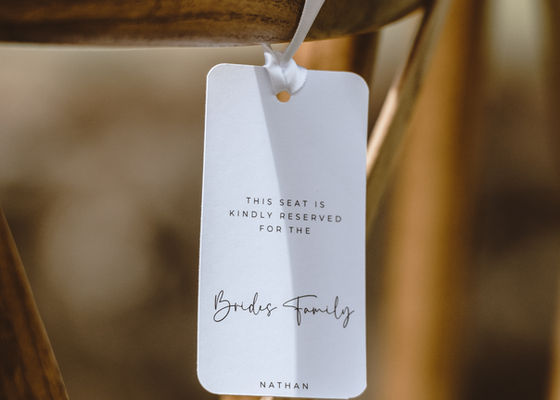 Little details like a name tag on a ceremony chair outdoors is placed lovingly by The Wedding Stylist