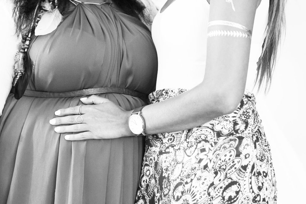 Image of pregnant stomach with hands on it.