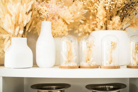 The Wedding Stylist studio hire items: dried florals in white vases and cloches.