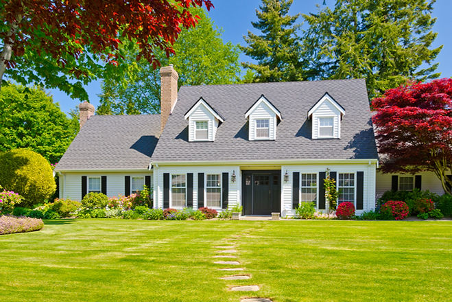 Custom built luxury house with nicely trimmed and landscaped front yard, lawn in a residen