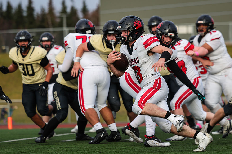 Juneau-Douglas High School: Yadaa.at Kalé senior Ethan Van Kirk (3) runs against South Anchorage during the Crimson Bears’ 42-12 loss to the Wolverines in the ASAA First National Bowl semifinal football game at South High School, Saturday, Oct. 17, 2026. South advances to play West Anchorage next weekend for the state championship. (Photo courtesy Stephanie Burgoon)