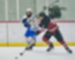 JDHS Crimson Bears hockey senior captain Elliot Welch wins a puck against the Palmer Moose during action this season at Treadwell Arena. (Klas Stolpe / Juneau Independent)