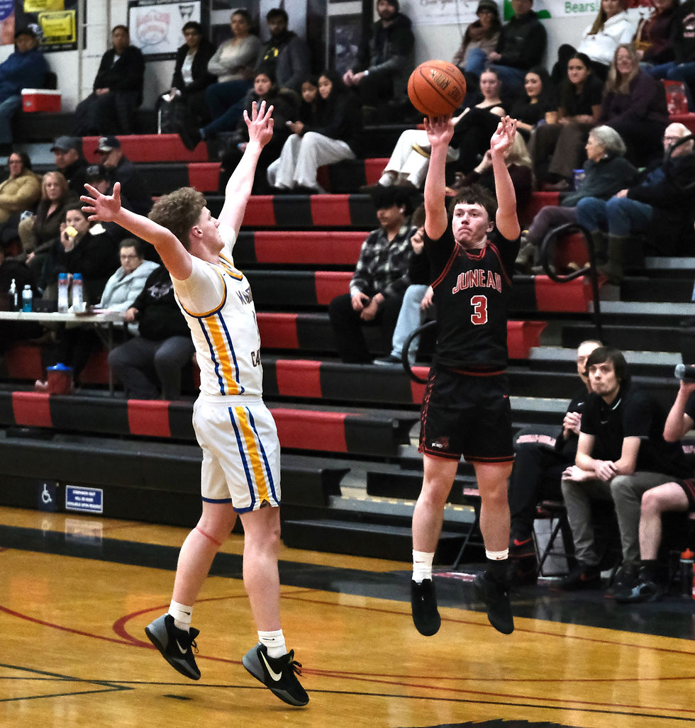 Juneau-Douglas High School: Yadaa.at Kalé senior Kurt Kuppert (3) shoots from the arc over Monroe sophomore Brayden Oleson during the George Houston Capital City Classic boys championship game at the GH Gymnasium on Tuesday, Dec. 30, 2025. (Klas Stolpe / Juneau Independent)