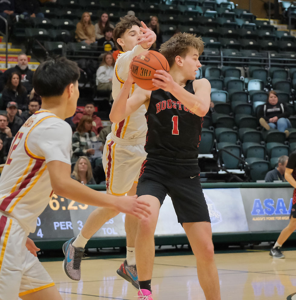 Mt. Edgecumbe junior Guy Goldsberry steals a ball from Houston senior Jaylon Jackson (1) during the Braves 79-35 win over the Hawks on Tuesday, March 18, at the March Madness Alaska 3A Boys Basketball State Championships in Anchorage's Alaska Airlines Center. (Klas Stolpe / Juneau Independent)