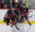 JDHS senior hockey alternate captains Isaac Phelps (24) and Nolan Cruz (23) lead the Crimson Bears onto the sheet during action this season at Treadwell Arena. (Klas Stolpe / Juneau Independent)