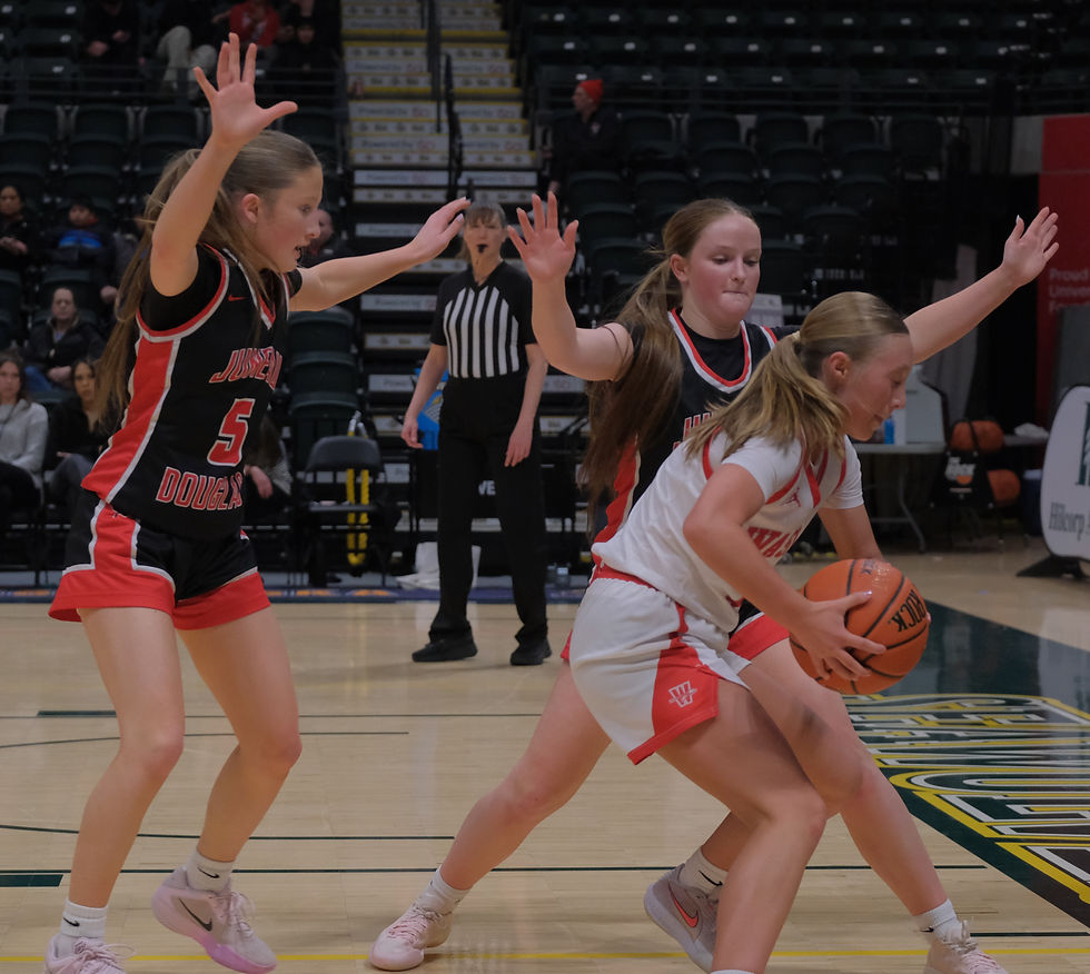 JDHS freshman Blythe Lockhart (5) and senior Cambry Lockhart defend Wasilla senior Mielee Merchant during the Crimson Bears' 69-42 loss to the Warriors in the consolation bracket semifinal of the 2026 March Madness Alaska 4A State Basketball Championships in Anchorage on Friday, March 20. (Klas Stolpe / Juneau Independent)