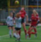 Juneau-Douglas High School: Yadaa.at Kalé sophomore Ayla Erickson wins a ball in the air from Colony sophomore Calico McIntyre (15) as JDHS senior Kenzie Simonson (7) and junior Riley Schultz and Colony senior Sammie Gerteisen (13) move in during the Crimson Bears' 1-0 win over the Knights at the Adair-Kennedy Memorial Park pitch, Saturday, May 9, 2026.  (Klas Stolpe / Juneau Independent)