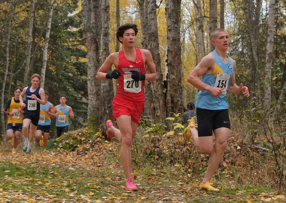 Wrangell junior Carter Howell (270) and Dillingham senior August Reigh (154) race during the boys Division III Alaska State XC Championships at Anchorage's Bartlett High School trails on Saturday, Oct. 3, 2026. (Klas Stolpe / Juneau Independent)