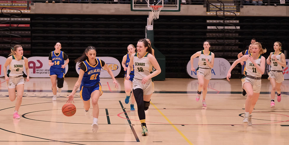 Metlakatla senior Saahdia Buffalo (21) leads a fast break ahead of Seward junior Regan Seibert (2), senior Mikinley Williams (12), junior Lia Shank (5), junior Grace Ann Fleming (11) and senior Ava Jagielski (10) during their semifinal game at the 2026 ASAA March Madness Alaska State Basketball Championships on Friday, March 13, 2026. (Klas Stolpe / Juneau Independent)