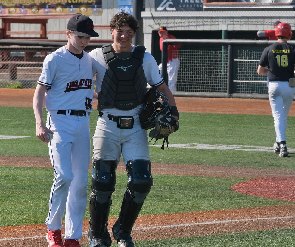 Juneau-Douglas High School: Yadaa.at Kalé senior closer Cayman Huff (16) is congratulated by senior catcher Nate Fick after the Crimson Bears' 11-1 semifinal win over the West Valley Wolfpack in the ASAA DI Baseball State Championships at Anchorage's Mulchay Stadium, Friday, June 5, 2026. JDHS plays Service in the championship game at 4:30 p.m. Saturday. (Klas Stolpe / Juneau Independent)
