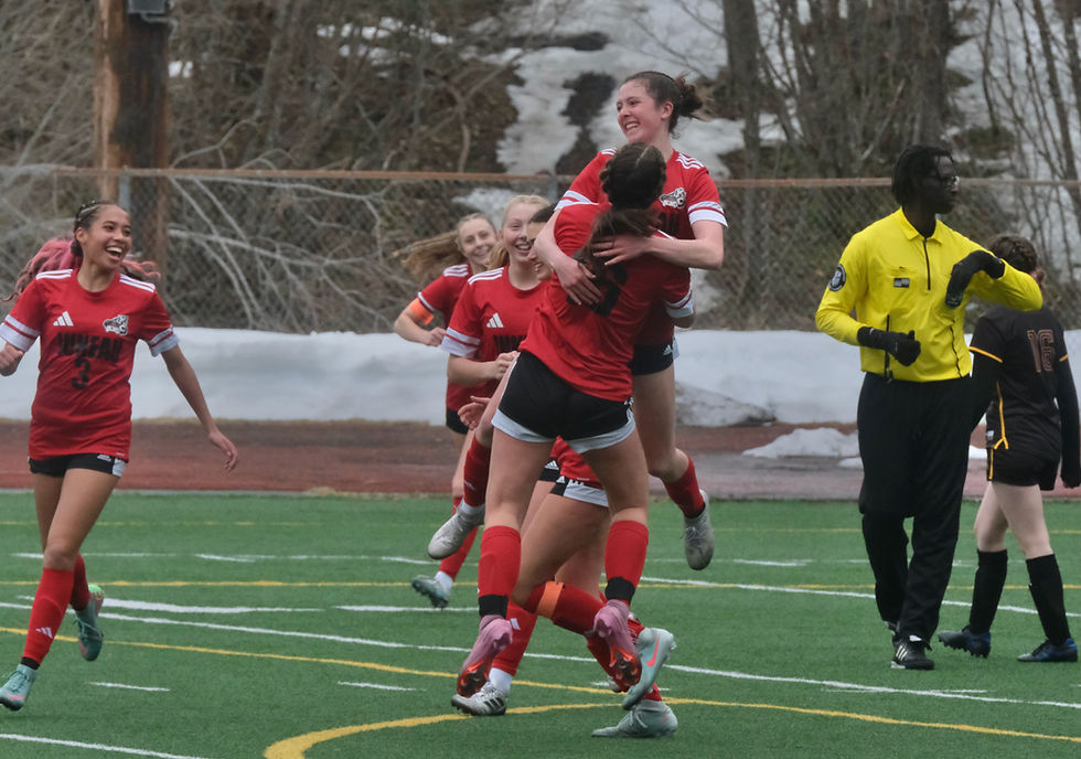 Juneau-Douglas High School: Yadaa.at Kalé freshman Maddie Dale and sophomore Ayla Erickson (16) celebrate Dale's goal against Lathrop during the Crimson Bears' 7-0 win over the Malemutes at Adair-Kennedy Memorial Park on Thursday, April 23, 2026. (Klas Stolpe / Juneau Independent)