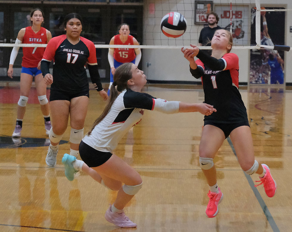 Juneau-Douglas High School: Yadaa.at Kalé sophomore Winter Osterhout (2) and senior June Troxel (1) play a ball during the Crimson Bears' 3-0 (25-15, 25-21, 25-17) match win over the Sitka Wolves at the George Houston Gymnasium on Friday, Aug. 21, 2026. (Klas Stolpe / Juneau Independent)