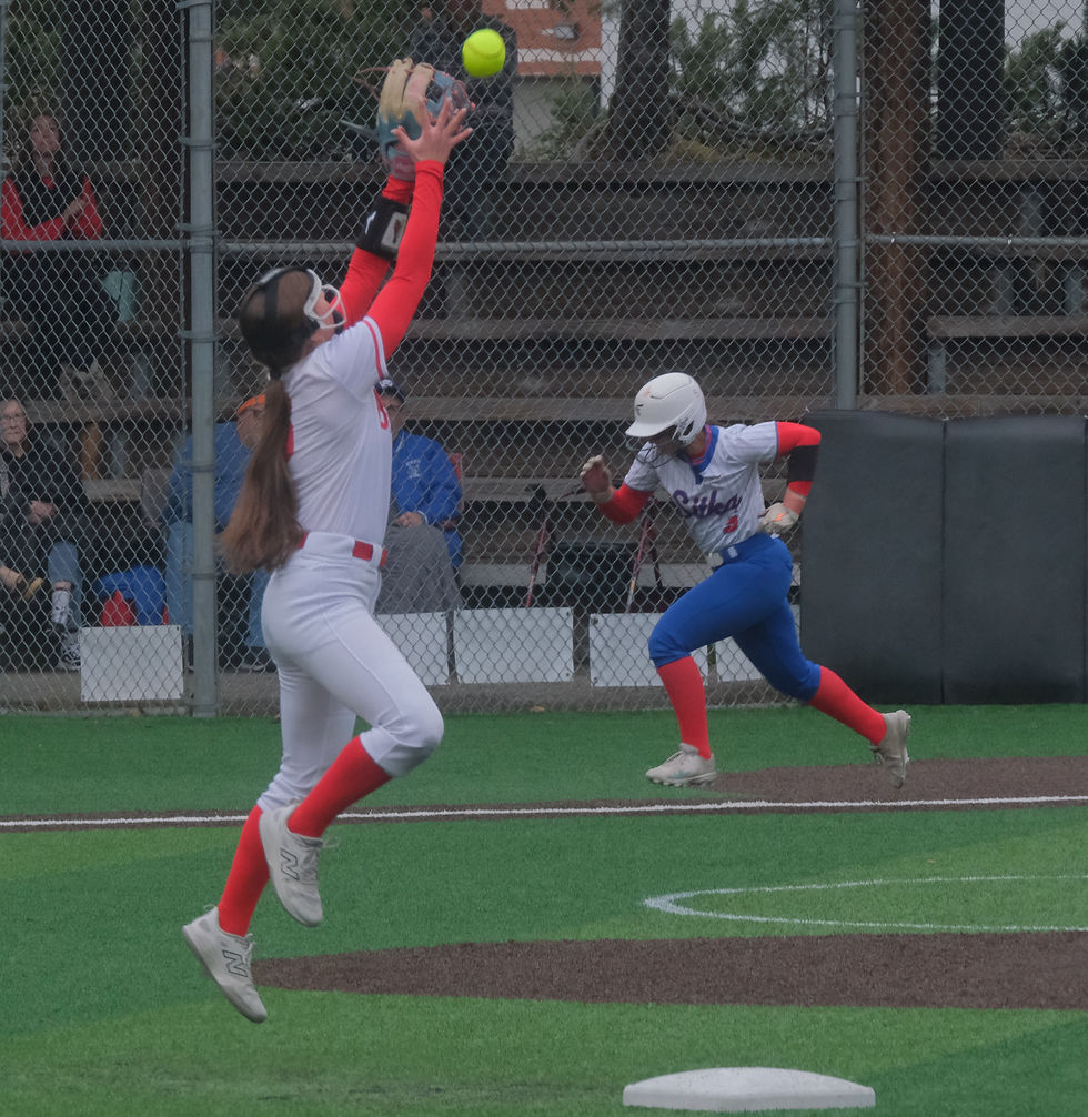 In this file photo Juneau-Douglas High School: Yadaa.at Kalé junior second baseman June Troxel reaches for a fly ball hit by Sitka senior Alina Lebahn during their game at Adair-Kennedy Memorial Park on Thursday, April 30, 2026.  (Klas Stolpe / Juneau Independent)