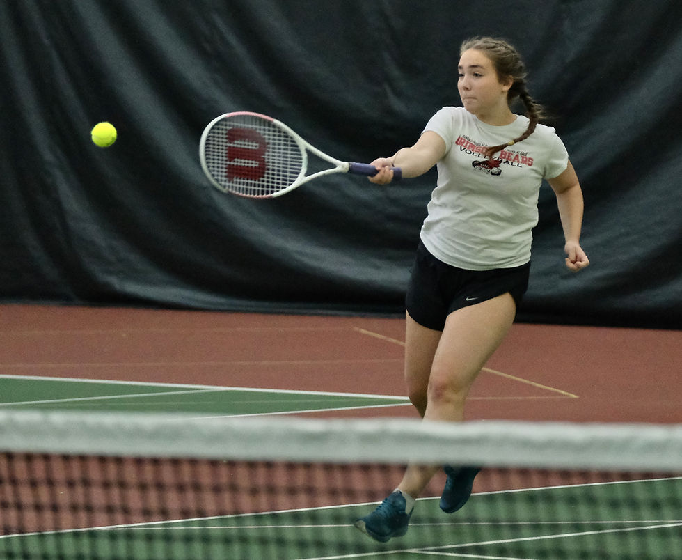 Juneau-Douglas High School: Yadaa.at Kalé senior Stahly Sheehan hits a forehand return during the Region V tennis championships at The Alaska Club in the Mendenhall Valley on Tuesday, Sept. 22, 2026. Sheehan, who has 11 years of hockey in Juneau, has played one season of tennis with the Crimson Bears. (Klas Stolpe / Juneau Independent)