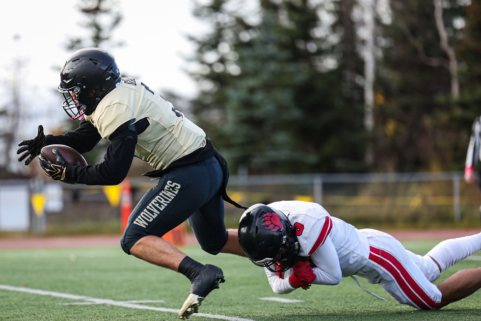 Juneau-Douglas High School: Yadaa.at Kalé senior Avei Tuvaifale (8) tackles South Anchorage senior Kaiden Coleman-Arroyo (3) during the Crimson Bears’ 42-12 loss to the Wolverines in the ASAA First National Bowl semifinal football game at South High School, Saturday, Oct. 17, 2026. South advances to play West Anchorage next weekend for the state championship. (Photo courtesy Stephanie Burgoon)