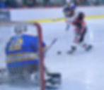 JDHS junior Caden Morris (18) takes a shot against Kodiak junior goalie Garrett Wood (12) during the Crimson Bears 3-1 win over the Kodiak Bears on Tuesday at Treadwell Arena. (Klas Stolpe / Juneau Independent)