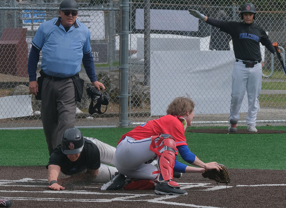 Juneau-Douglas High School: Yadaa.at Kalé Crimson Bears senior Riley Fick, wearing the colors of four of the eight seniors who began their baseball journey with the now-defunct Thunder Mountain High School Falcons, slides safely into home plate against Sitka during senior celebrations at Adair-Kennedy Memorial Park on Saturday, May 9, 2026. (Klas Stolpe / Juneau Independent)