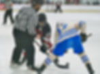 In this file photo Juneau-Douglas High School: Yadaa.at Kalé senior Nolan Cruz (23) wins a faceoff against Palmer at Treadwell Arena this season. JDHS defeated Delta Junction on the road 11-1 on Friday, Jan. 16, 2026. (Klas Stolpe / Juneau Independent)