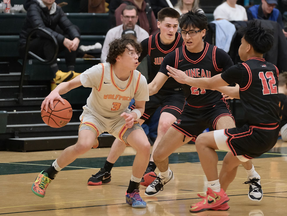 West Valley junior Jayden Miranda (3) is triple-teamed by Juneau-Douglas High School: Yadaa.at Kalé seniors Brandon Casperson, Tyler Frisby (21) and Joren Gasga (12) in an opening game at the ASAA March Madness Alaska State Basketball Championships, Wednesday, March 18, 2026. (Klas Stolpe / Juneau Independent)