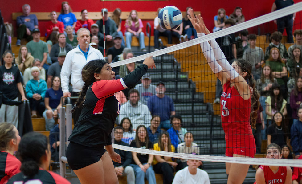 Juneau-Douglas High School senior Liliane Veikoso spikes as Sitka senior Bristol Clifton blocks during the Crimson Bears' 3-1 (26-24, 24-26, 26-24, 25-17) loss at the home of the Sitka Wolves on Friday. JDHS won on Saturday 3-2 (17-25, 25-22, 27-25, 22-25, 15-7). JDHS hosts Ketchikan next weekend. (James Poulson / The Daily Sitka Sentinel)