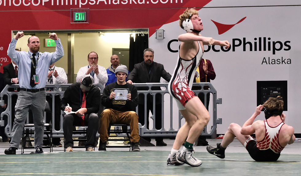 Wrangell High School coach Jack Carney, left, and junior Jackson Carney celebrate Jackson's pin over Kenai Central High School senior Conner Cook, right, in the Division II 145-pound final during ASAA/First National Bank Alaska Wrestling State Championships at Anchorage's Alaska Airlines Center on Saturday, Dec. 20, 2025. The pin also broke a tie with Kenai for the team championship. (Klas Stolpe / Juneau Independent)