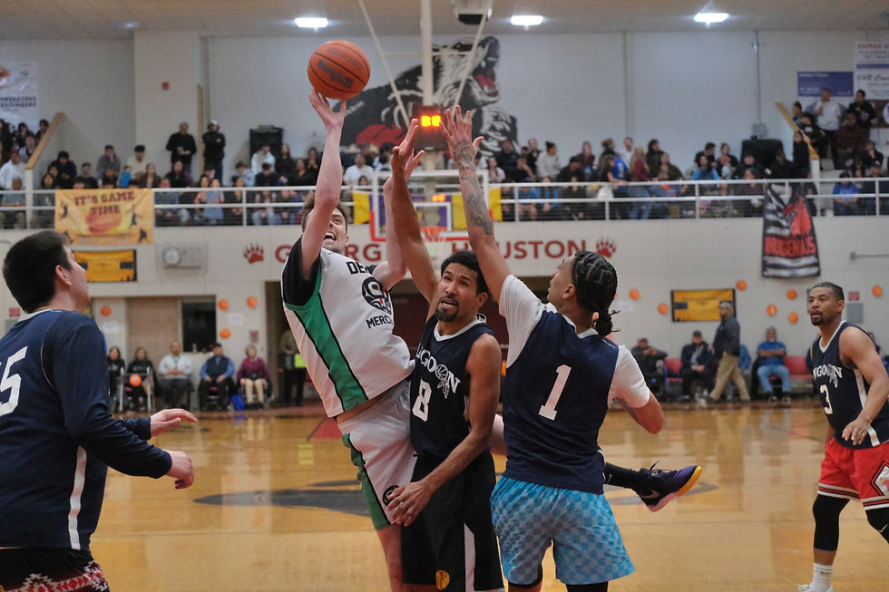 Haines' Kaleb Tompkins gets a tough shot off under pressure from Angoon's Clayton Edwin (8) and Tajaun Jamestown (1) as Angoon's Kendrick Payton, left, and Jonathan Jack-Nixon (3) react on Saturday, March 28, 2026, at the Juneau Lions Club 77th Gold Medal Basketball Tournament in the Juneau-Douglas High School: Yadaa.at Kalé George Houston Gymnasium. (Klas Stolpe / Juneau Independent)