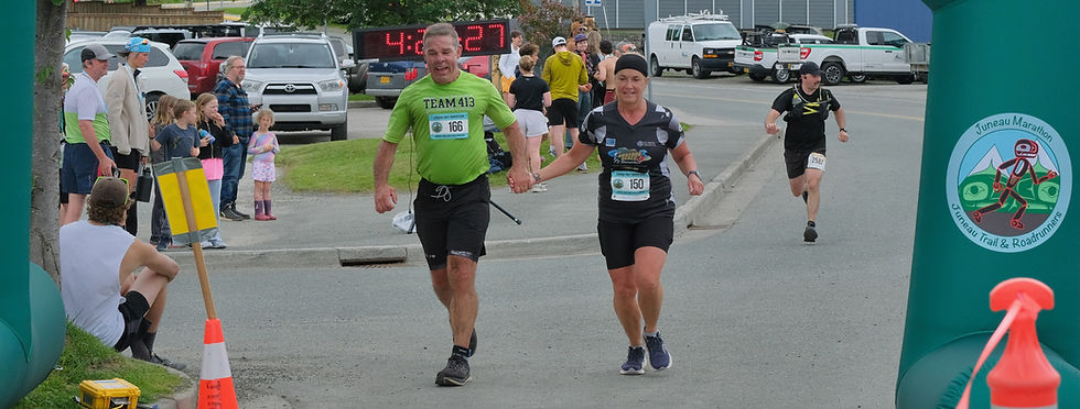 Billy McDonough and wife Judy McDonough, both 61, of Scranton, Pennsylvania, cross their 50th state half marathon finish line at Savikko Park on Saturday, July 25, 2026. (Klas Stolpe / Juneau Independent)