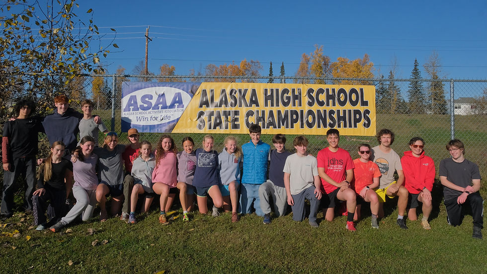 The Juneau-Douglas High School: Yadaa.at Kalé Crimson Bears cross country running team pose for a photo at the Bartlett High School trails state course on Friday, Oct. 2, 2026. The Crimson Bears race in the Division I ASAA Alaska High School State Championships on Saturday. (Klas Stolpe / Juneau Independent)