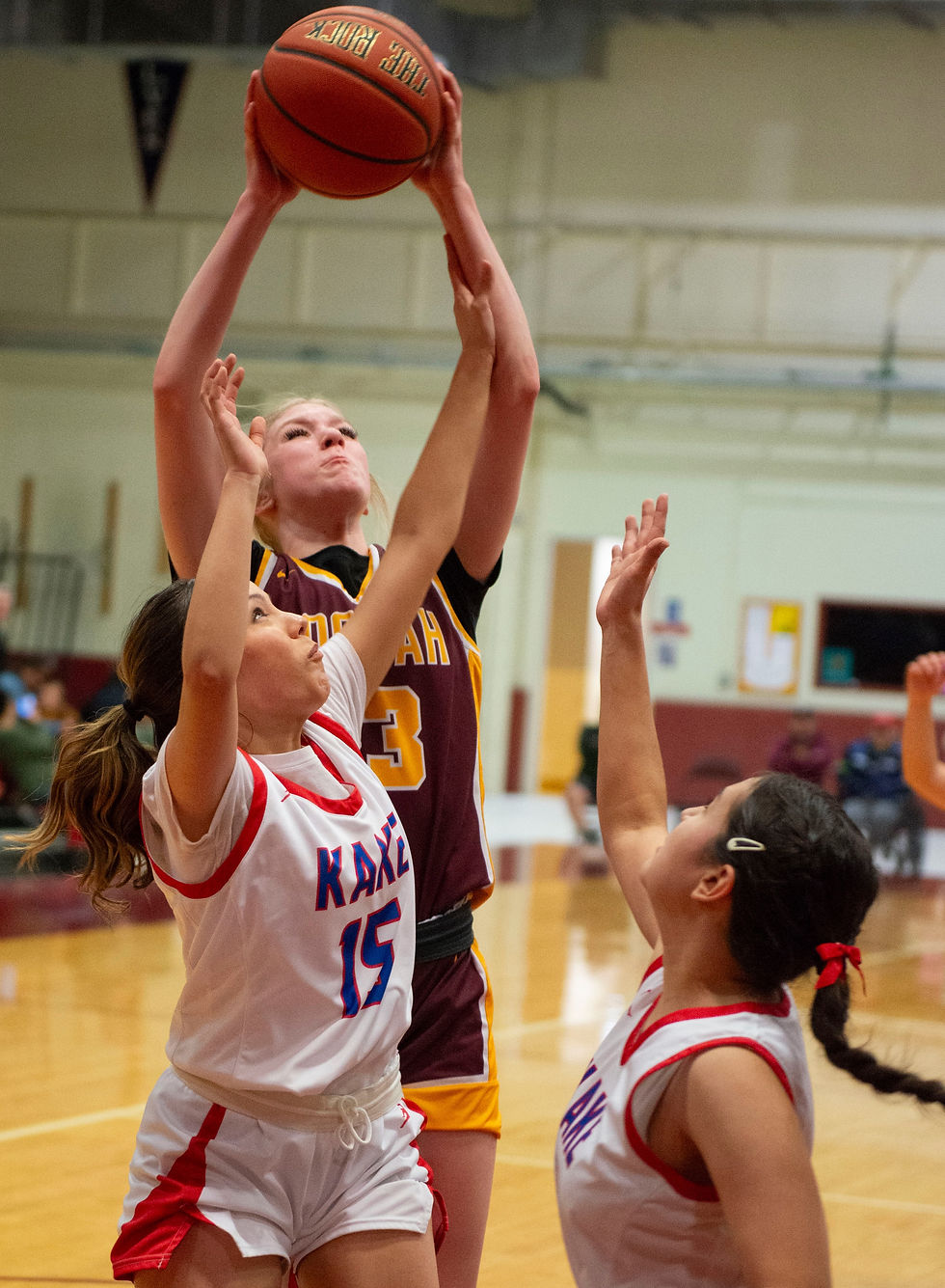 Hoonah High School's Paige Woitte shoots over Kake's Eden Hallingstad during the girls Region V 1A championship game between the Kake Thunderbirds and the Hoonah Braves Friday night, Feb. 27, 2026, at Mt. Edgecumbe High School's BJ McGillis gym in Sitka. (James Poulson / Daily Sitka Sentinel)