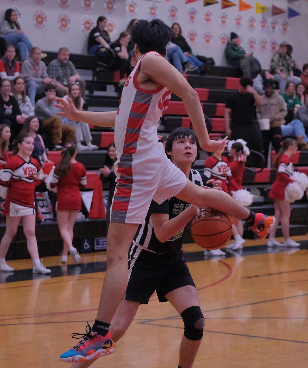 Wrangell sophomore Kai Wigg (32) deflects a fake with his foot as Craig freshman Tate Arndt pumps the ball during the Wolves' 61-43 win over the Panthers at the 2026 Region V 2A Basketball Tournament on Wednesday, March 4, in the Juneau-Douglas High School: Yadaa.at Kalé George Houston Gymnasium. (Klas Stolpe / Juneau Independent)