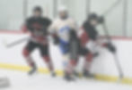 In this file photo Juneau-Douglas High School: Yadaa.at Kalé seniors Elias Schane (18) and Isaace Phelps (24) box out a Palmer player at Treadwell Arena this season. JDHS defeated Delta Junction on the road 11-1 on Friday, Jan. 16, 2026. Crimson Bears senior night is at 6 p.m. Sunday against Kodiak at Treadwell Arena. (Klas Stolpe / Juneau Independent)