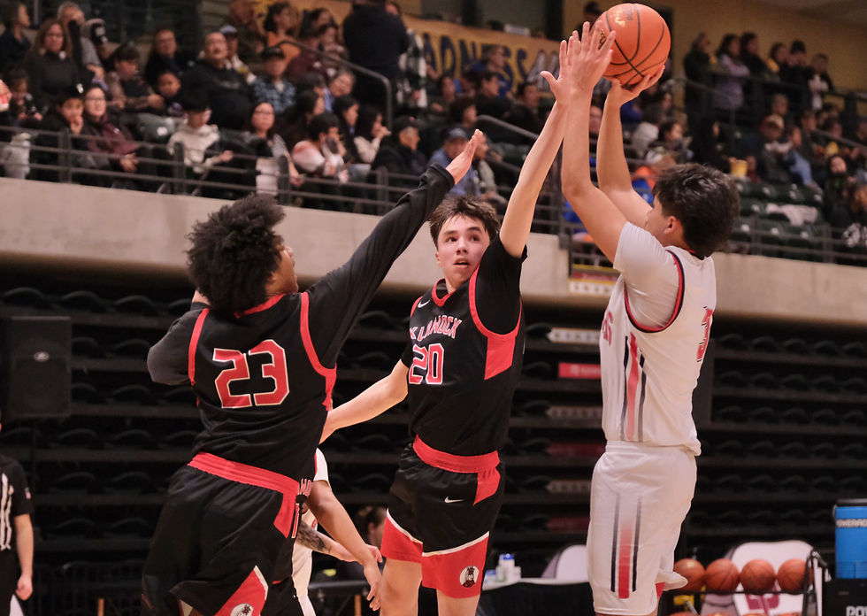 Klawock sophomore Dahani Peel (23) and junior Paul Lingley (20) defend a shot by Walter Northway senior Terrence Nutting-Titus (3) during the Chieftains 64-60 loss to the Warriors in the 2026 ASAA March Madness Alaska 1A Basketball State Championships on Wednesday, March 11, in Anchorage's Alaska Airlines Center. (Klas Stolpe / Juneau Independent)