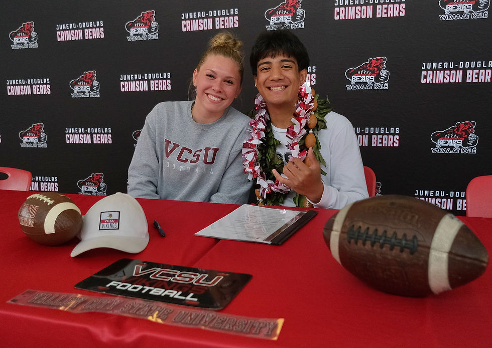 Juneau-Douglas High School: Yadaa.at Kalé Crimson Bears senior Noah Ault and girlfriend Nellie Stowers pose at Ault's letter of intent signing on Tuesday, May 26, 2026, in the JDHS commons to attend Valley City State University in Valley City, North Dakota, and play football for the Vikings.  (Klas Stolpe / Juneau Independent)