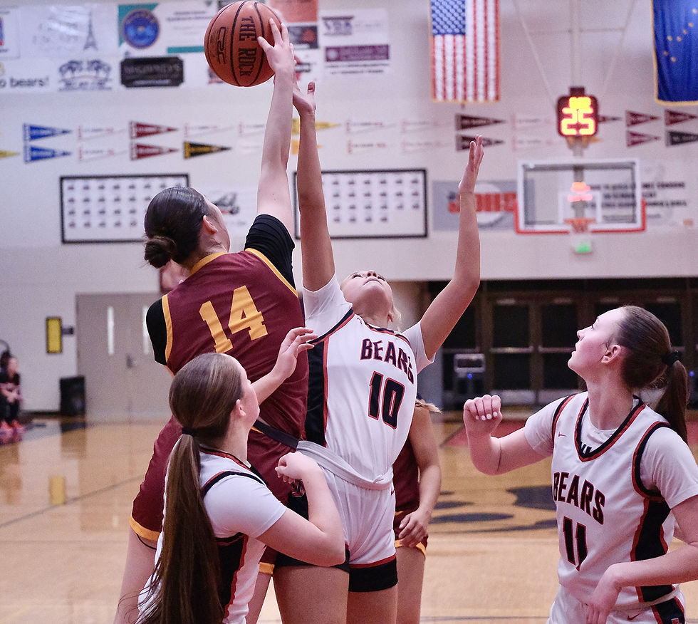 Mt. Edgecumbe freshman Evangeline Hank (14, Pt. Hope) tips a rebound away from Juneau-Douglas senior Cambry Lockhart (3), sophomore Freyja Shelton-Walker (10) and senior Gwen Nizich (11) during the Lady Braves 55-26 win over the Crimson Bears at JDHS Friday, Feb. 13, 2026. (Klas Stolpe / Juneau Independent)