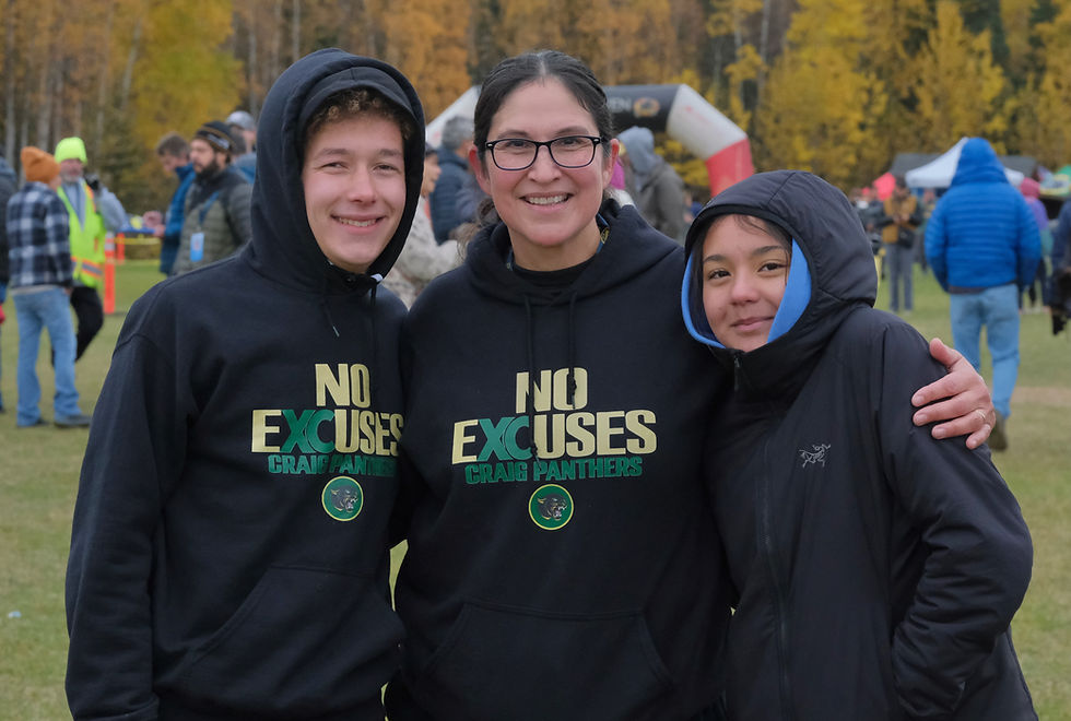 Craig DIII boys state champion senior Aulix Nelson, Craig coach/AD Tina Steffen and Craig junior eighth place DIII girls finisher Jayla Edenshaw pose for a photo at the Alaska State XC Championships at Anchorage's Bartlett High School trails on Saturday, Oct. 3, 2026. (Klas Stolpe / Juneau Independent)