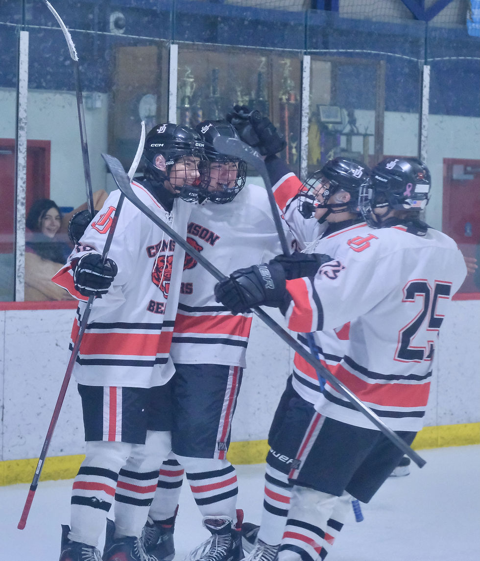 JDHS players celebrate a goal by freshman Paxton Willoughby during the Crimson Bears 3-1 win over the Kodiak Bears on Tuesday at Treadwell Arena. (Klas Stolpe / Juneau Independent)