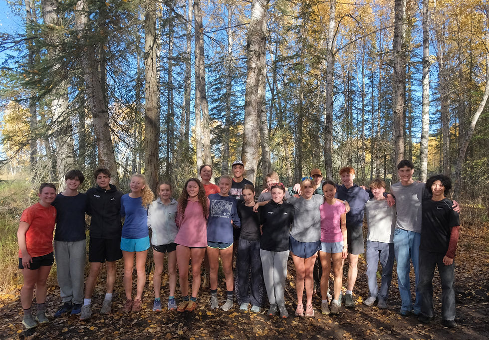 The Juneau-Douglas High School: Yadaa.at Kalé Crimson Bears cross country running team pose for a photo along the Bartlett High School trails state course on Friday, Oct. 2, 2026. The Crimson Bears race in the Division I ASAA Alaska High School State Championships on Saturday. (Klas Stolpe / Juneau Independent)