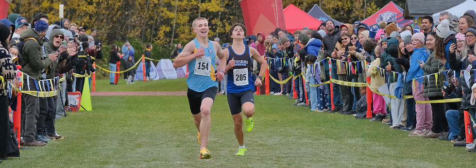 Dillingham senior August Reigh (154) and Petersburg sophomore Andi Mihai (205) sprint to the finish of the boys Division III Alaska State XC Championships at Anchorage's Bartlett High School trails on Saturday, Oct. 3, 2026. (Klas Stolpe / Juneau Independent)