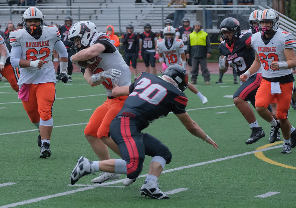 JDHS senior linebacker Jaxin Jim (20) tackles a West Anchorage runner during a September game. Jim and his senior football classmates will be celebrated at 2:30 p.m. Saturday, Oct. 3, 2026, at Adair-Kennedy Memorial Park field before the Crimson Bears host the Bartlett Golden Bears at 3 p.m. (Klas Stolpe / Juneau Independent)