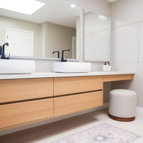Modern floating oak vanity with makeup area by MiDa interior
