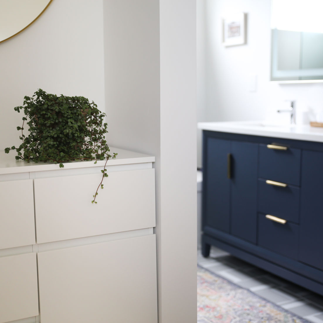 Entrance from master bedroom to a modern bathroom with gray tiles and dark blue vanity in Sunnyvale by MiDa interior