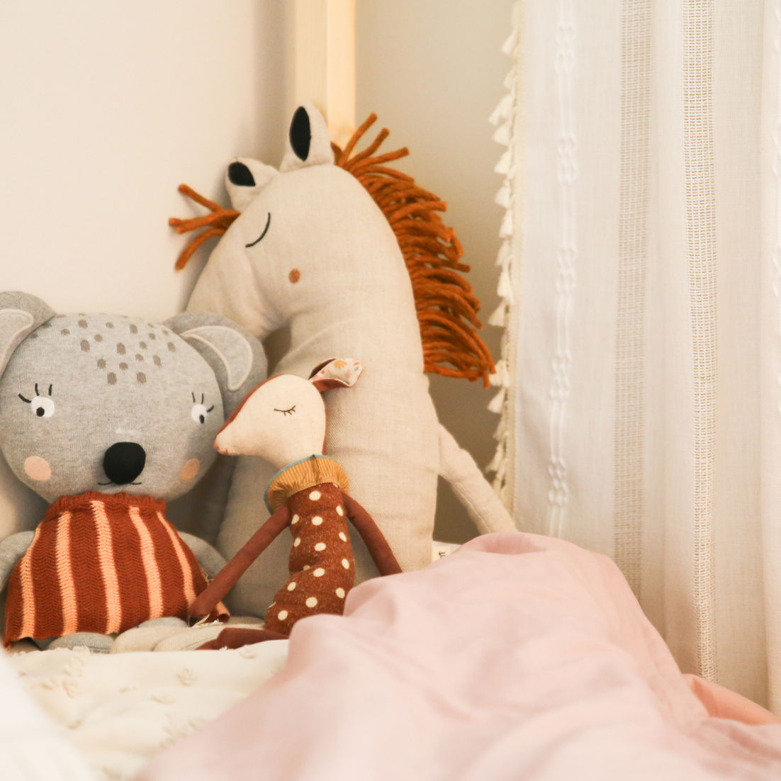 Boho chic stuffed animals on bed in girl's bedroom in Sunnyvale by MiDa interior
