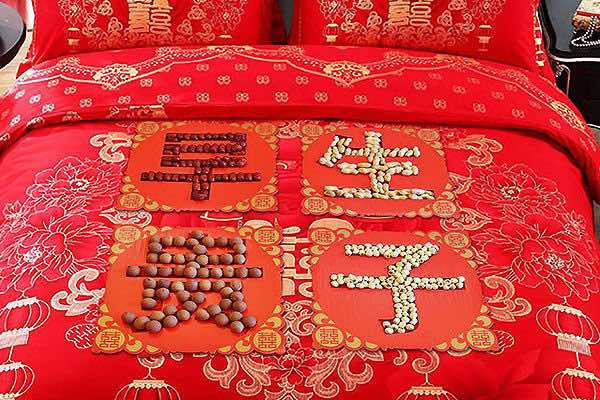 Traditional Chinese Wedding Bed Decorated with Date, Peanut, Longan, and Lotus Seed.