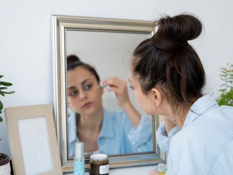 A woman applying retinol serum