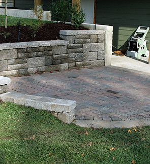 retaining wall closeup staggered concrete blocks patio pavers patio deck backyard landscap