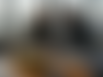 Investors meeting in office with gold bars and city view