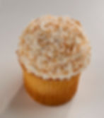Our coconut cake topped with buttercream and rolled in toasted coconut.