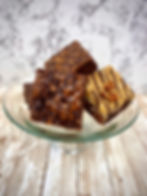 just baked double Chocolate Fudge, German Chocolate, and Reese's Peanut Butter brownies on a platter